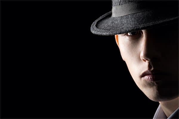 Understanding Low Key Lighting Example: Portrait of young man in hat