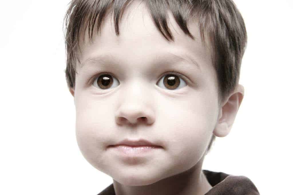 Young Boy looking at flash bouncing into umbrella