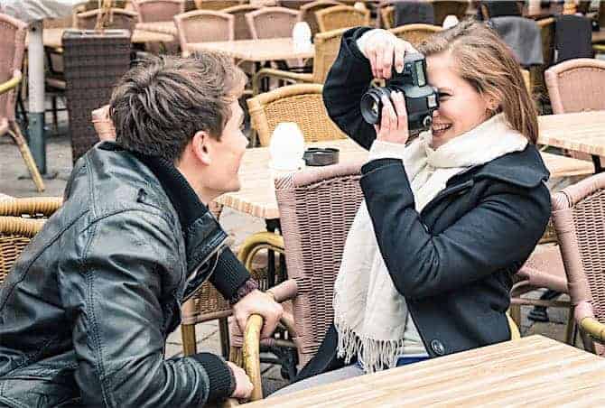 Girlfriend take a photo of the Boyfriend - Happy couple outdoors Taking Sharp Images: 11 Easy Tips for Beginners