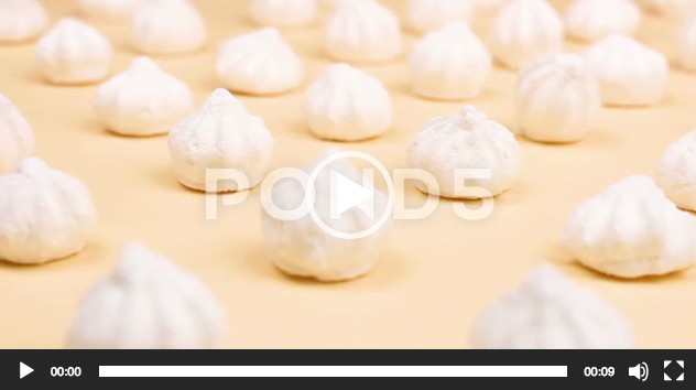 Women's hands take sweets from a beautiful pastel yellow surface