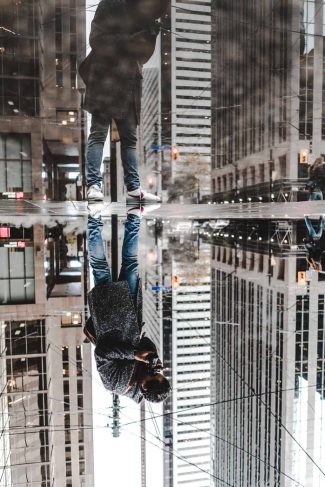 Forced perspective photography of a skyscraper reflection