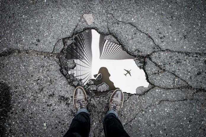 Forced perspective photography of a puddle in New York