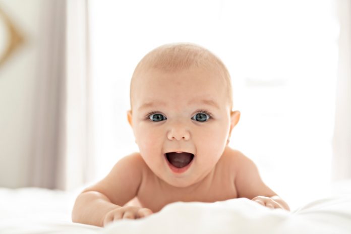 Baby with bright eyes posing