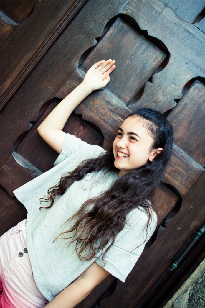 Portrait of girl by door