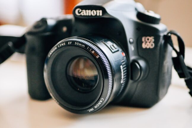 Canon 60D on a desk with the Canon EF 50mm f/1.8 II mounted.