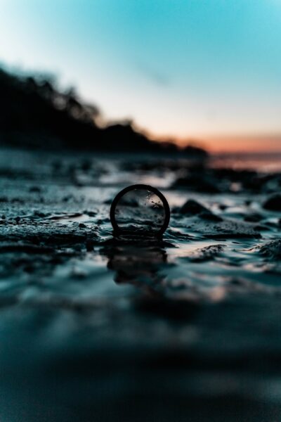 Filter standing up in watery mud with blue and orange sky in the background