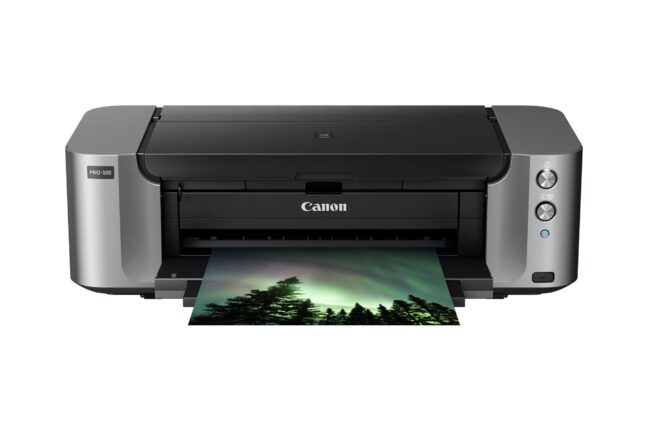 The Canon PIXMA Pro-100 printing out a photo of trees beneath the aurora at night