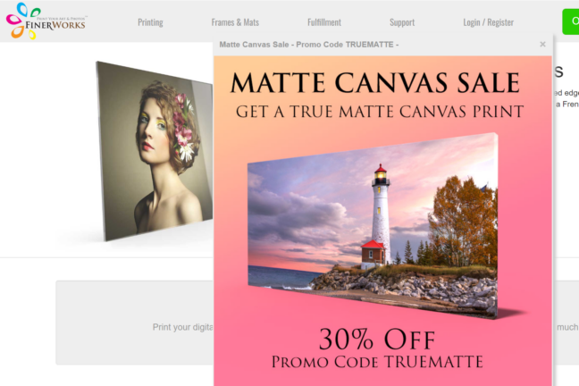 FinerWorks home page showing a matte canvas sale announcement with a lighthouse landscape canvas print image.