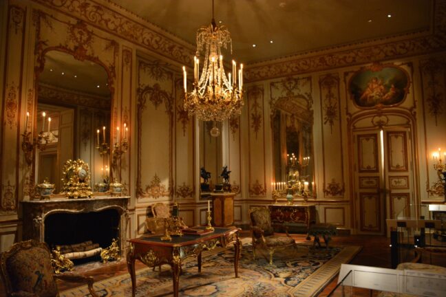 Beautiful room with candle-lit chandelier and antique furniture