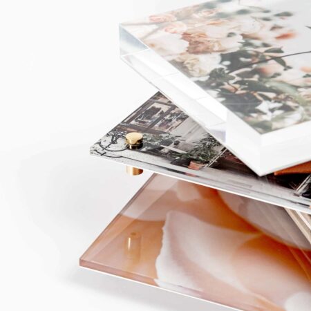 A close-up of the sides of several acrylic prints stacked on top of one another.