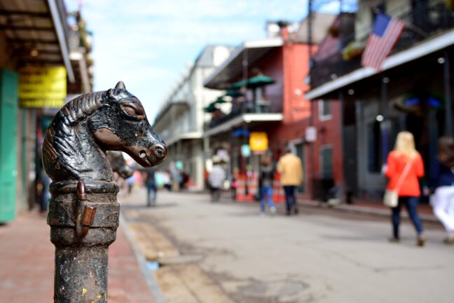 Example of a Shallow Depth of Field Photo - street and horse shaped pole sharp in the foreground.