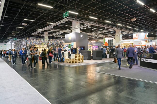 People walking around at a photography trade show.