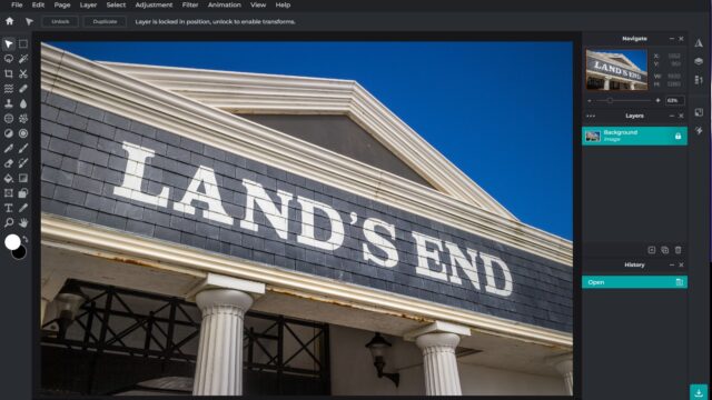 The Pixlr editing screen with tools and an image of a Land's End store against a blue sky.