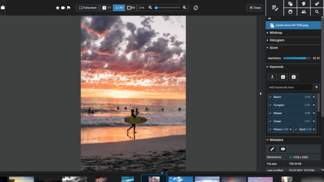 The main image view in Excire Foto 2024 showing a photo of a surfer on the beach at sunset.