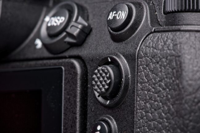 Detail of a modern mirrorless Nikon Z6 digital camera body. Thumb control knock and back button auto focus.