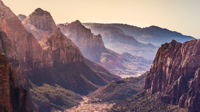 Telephoto Panorama of Zion Canyon at Dusk from the Angel's Landing Hiking Trail, with the East Temple and the Virgin River Visible.