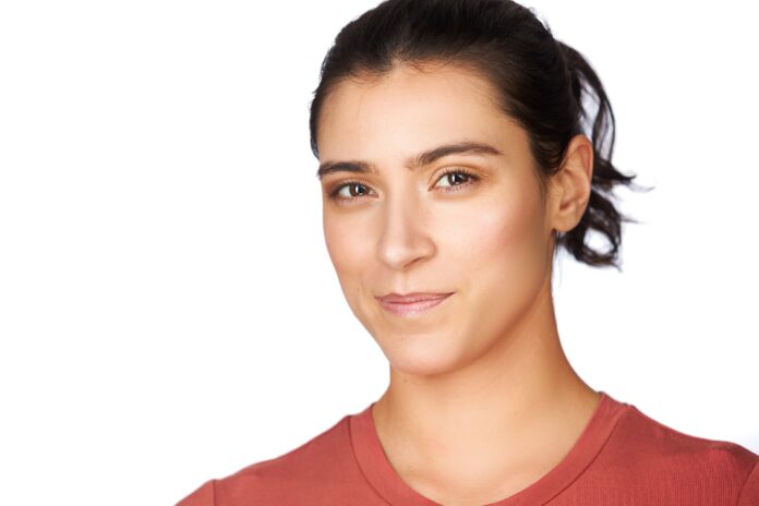 Headshot photo of woman with catch lights clearly showing in her eyes.