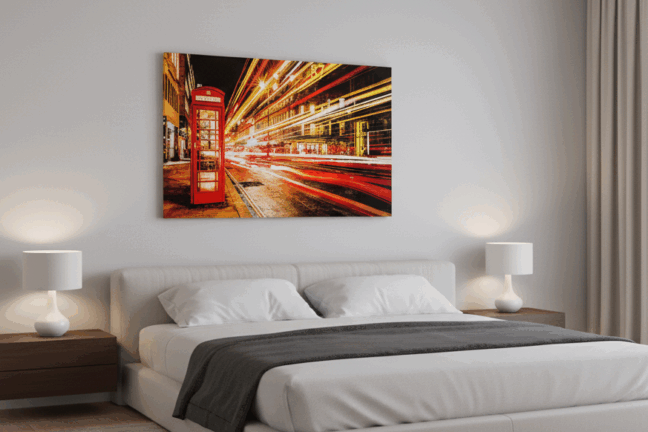 Modern minimalist bedroom with a cozy bed, sleek nightstands, and a vibrant London cityscape art print featuring a red phone booth and light trails.