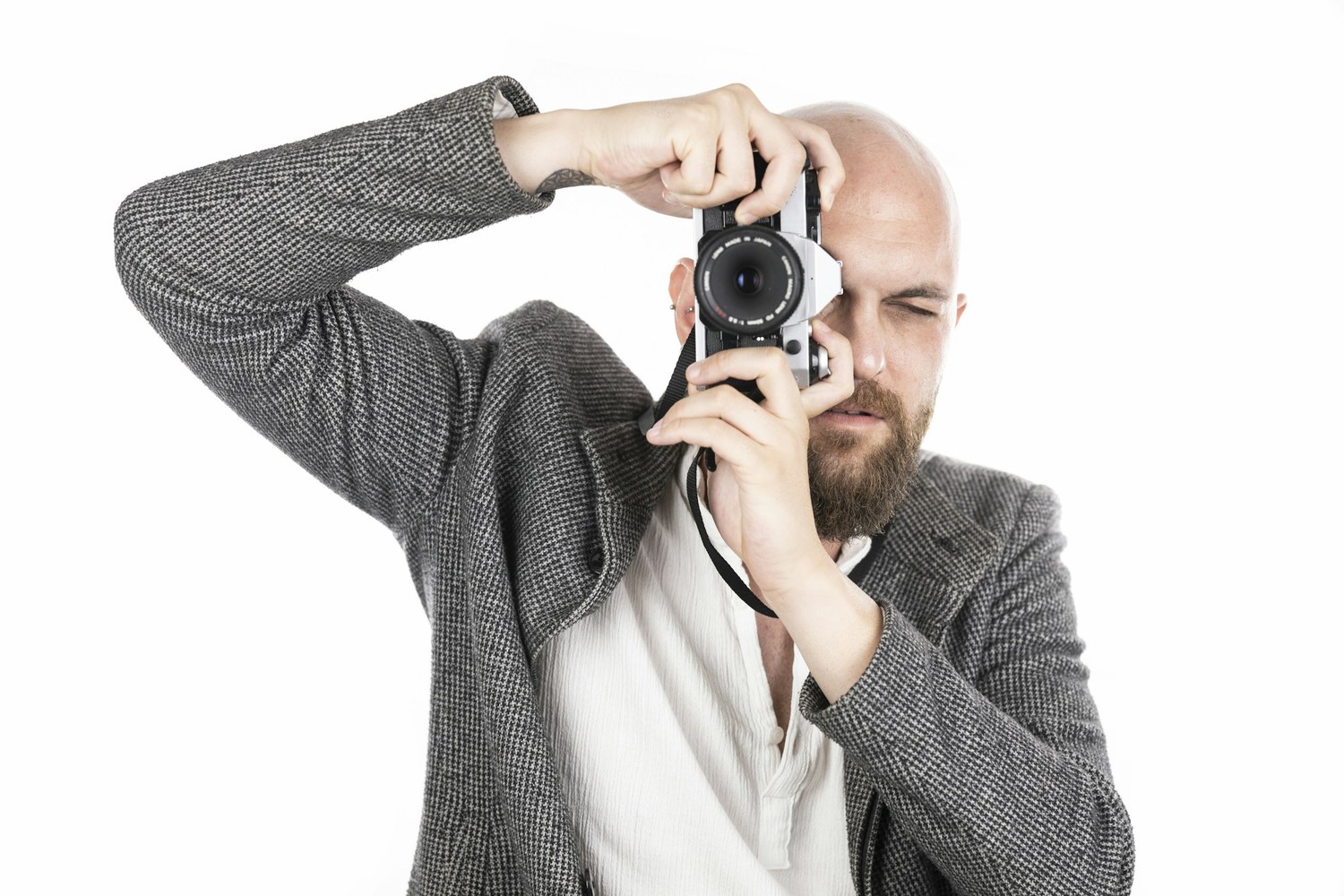 Press photographer holding a professional camera at an event — the workflow Canon's C2PA Authenticity Imaging System is built to harden